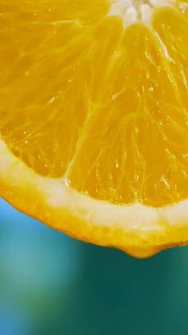 Sliced orange flesh on green background. Healthy fruit display with vibrant colors. Fresh juice droplets flow from slices, highlighting juiciness. Ideal for refreshing snacks and vitamin boost