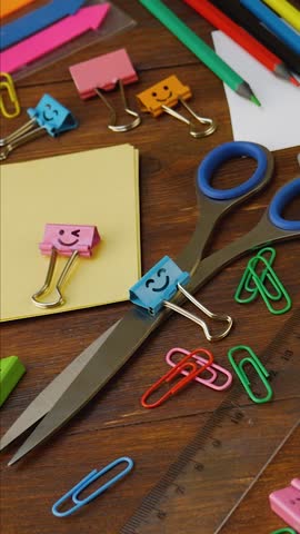 Stationery on a brown background. Back to school concept. Pens, pencils, rulers, erasers, paperclips. Tools for students and professionals