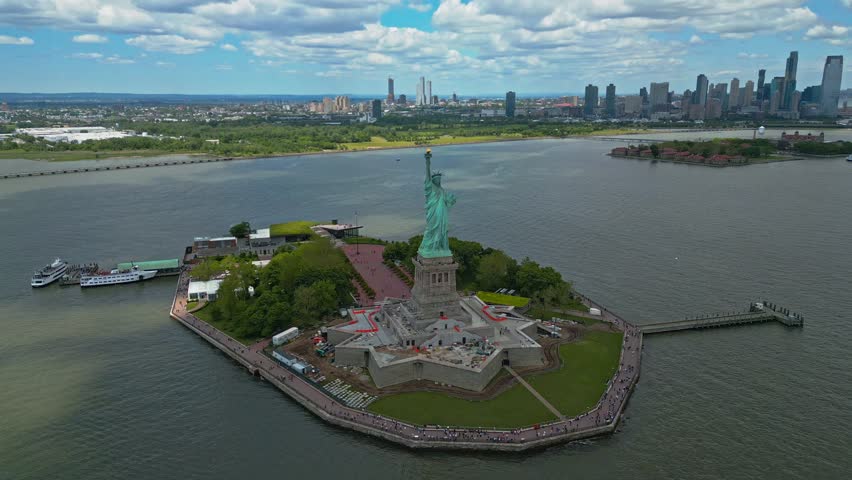 Panoramic aerial view Statue of Liberty in New York City, NY, USA. The Statue of Liberty over the Panorama of NYC. New York city skyline with statue of Liberty. The statue of Liberty and Manhattan.