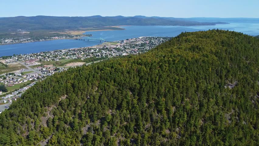 Breathtaking aerial footage of Sugarloaf Mountain, an ancient volcanic monolith in Atholville, New Brunswick. The drone captures the mountain
