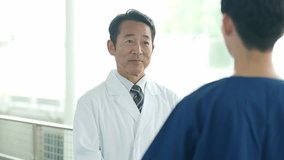male asian doctor and nurse talking in hospital lobby - Powered by Shutterstock - Get 15% off with code: PIKWIZARD15
