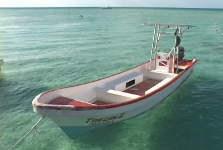 Series with boat tied to dock in Mexico.