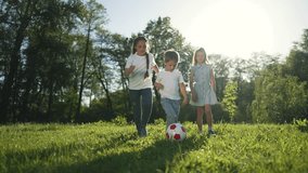 Children playing soccer ball park. Kids enjoying team game outdoors. Happy children kicking ball green park. kids having fun with soccer ball. Children team playing together. Outdoor park activity. - Powered by Shutterstock - Get 15% off with code: PIKWIZARD15
