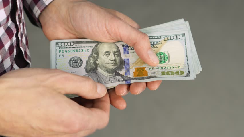 Hands Counting Money Closeup of 100 Dollar Bills Being Counted