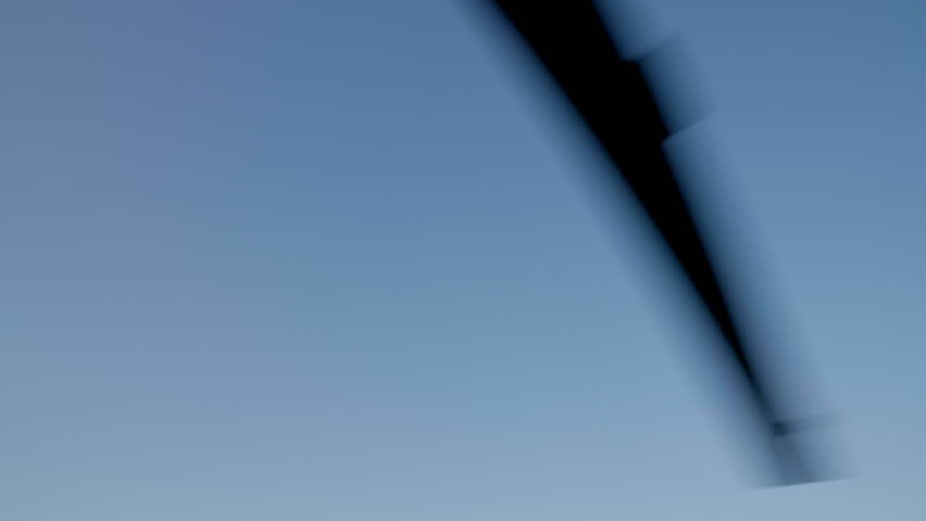 Helicopter propellers rotating against blue sky background