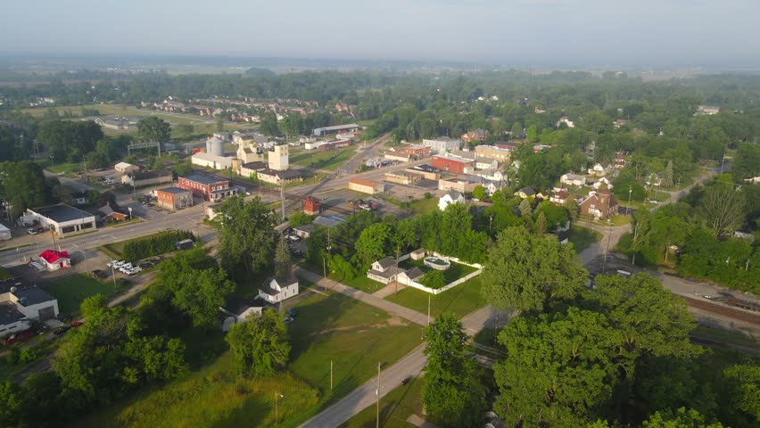Small town of Carlton with foggy horizon in Michigan, USA, aerial drone view