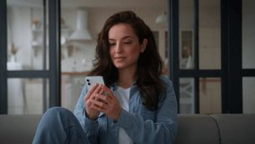 Caucasian woman user girl female housewife homeowner at home apartment couch sofa using mobile phone smartphone app browsing web service social media internet online shopping watching video cellphone - Powered by Shutterstock - Get 15% off with code: PIKWIZARD15