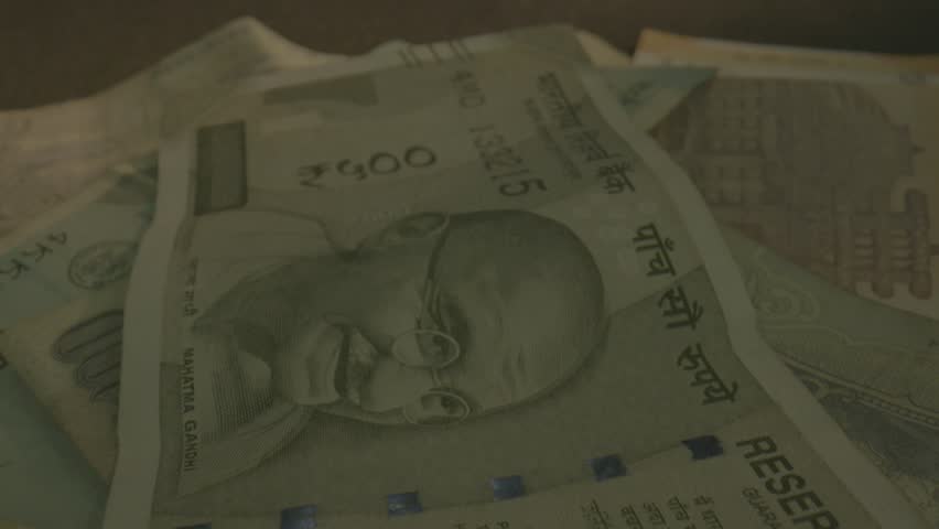 Indian currency note track shot. camera track in to Indian currency. 500 rupees note, 10 rupees note