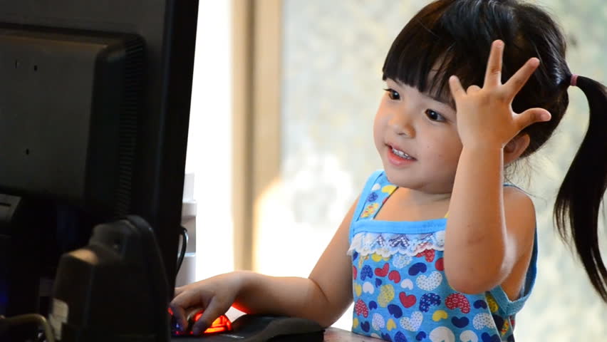 cute asian little girl play computer (three action shot)