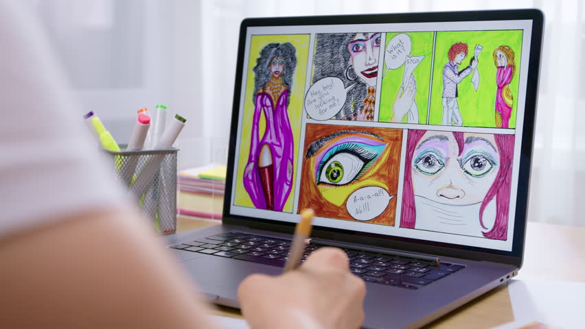 A female artist uses a laptop to work on storyboards of comic book characters.