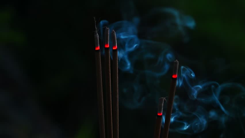 incense sticks smoke for Buddhist rituals smoke at night on the pagoda close-up