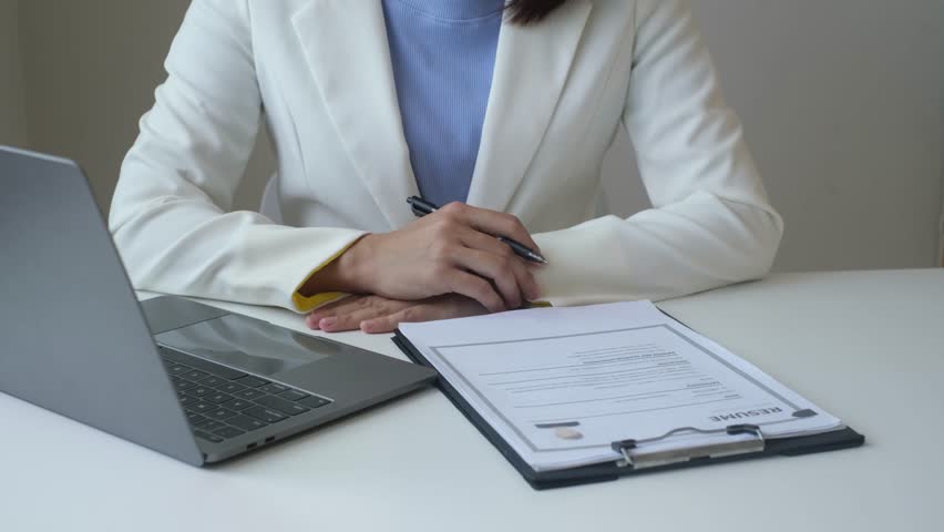 Executive CEO businesswoman checking job applicant documents resumes, interviews, and signing to approve the contract in the office room.