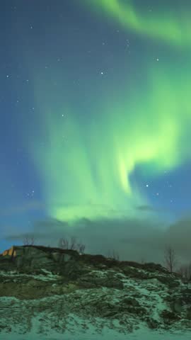 Tromso Norway time lapse of the aurora northern lights winter landscape at Rorvikneset Sommaroy (vertical)
