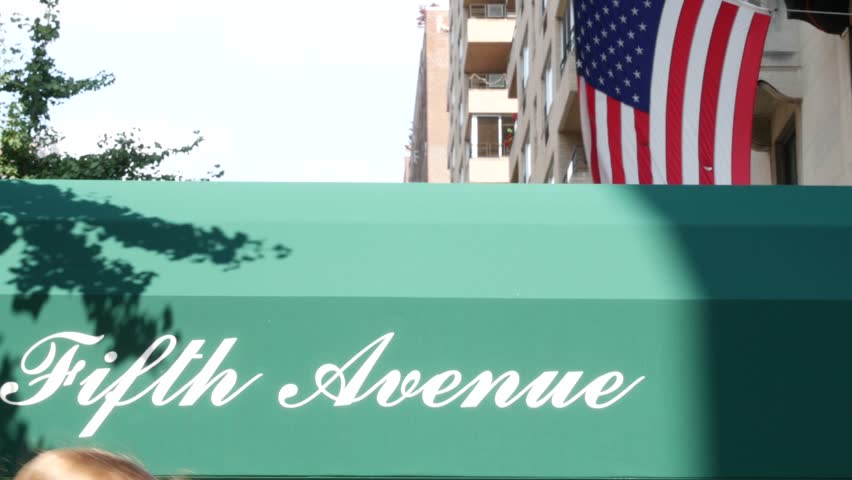 Fifth avenue, 5 ave sign, Manhattan midtown architecture, New York City 5th av. Real estate, residential property in USA. Classic building entrance signage. United States of America flag.