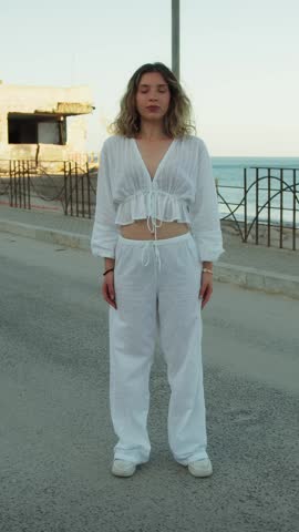 Girl Dances Rap In White Clothes On The Street Near The Sea