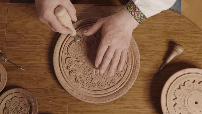 Handcarved wooden plate with intricate designs, blending artistry and traditional techniques