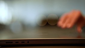Closeup side view of unrecognizable female entrepreneur opening laptop and typing on keyboard sitting at table with bokeh light on blurred background. Close-up of woman hands engaged in work. - Powered by Shutterstock - Get 15% off with code: PIKWIZARD15