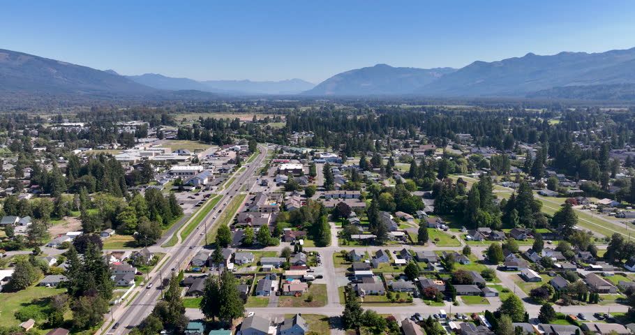 Overhead Landscape of Sedro-Woolley, Washington Homes, Highway 20, and Cascade Mountains During Summer