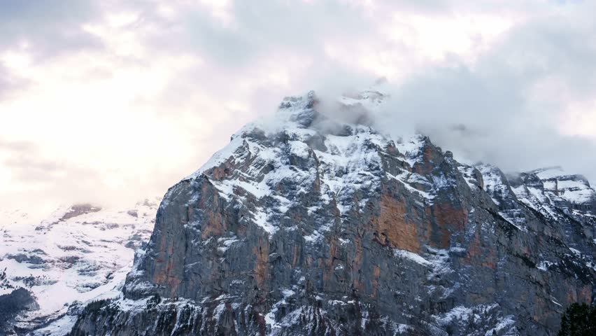 Mont Blanc, Chamonix, France. Time Lapse of Clouds Covering Snow Capped Peaks of French Alps