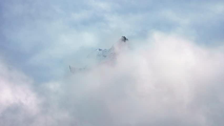 Mont Blanc, Chamonix, France. Time Lapse of Clouds Covering Snow Capped Peaks of French Alps