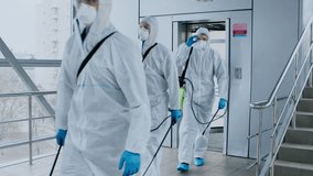 A healthcare worker wearing protective gear steps out of an elevator in a medical facility, showcasing the precautions taken during patient care in a clinical environment. - Powered by Shutterstock - Get 15% off with code: PIKWIZARD15