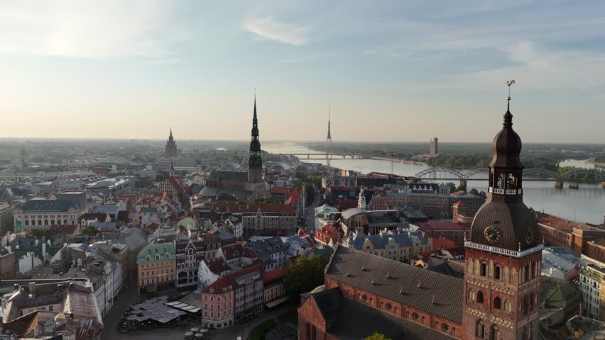 Aerial view of the spire of Riga Dome Cathedral, St. Peter's Church, Daugava River and the historic city center in the afternoon at sunset on a summer day, Latvia, Europe