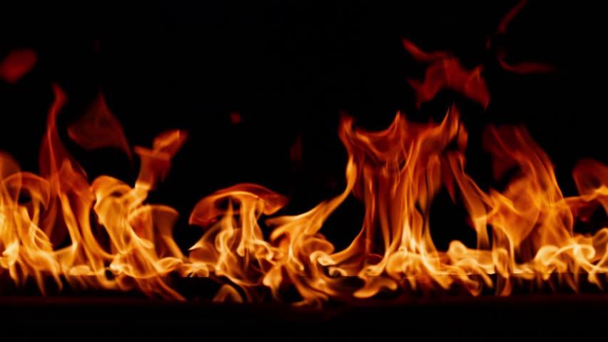 Fire, burning flame. Tongues of orange flame. Bright burning flames on a black background. Fire in slow motion. Wall of Real fire, abstract background. Dancing fire, Super slow motion video.