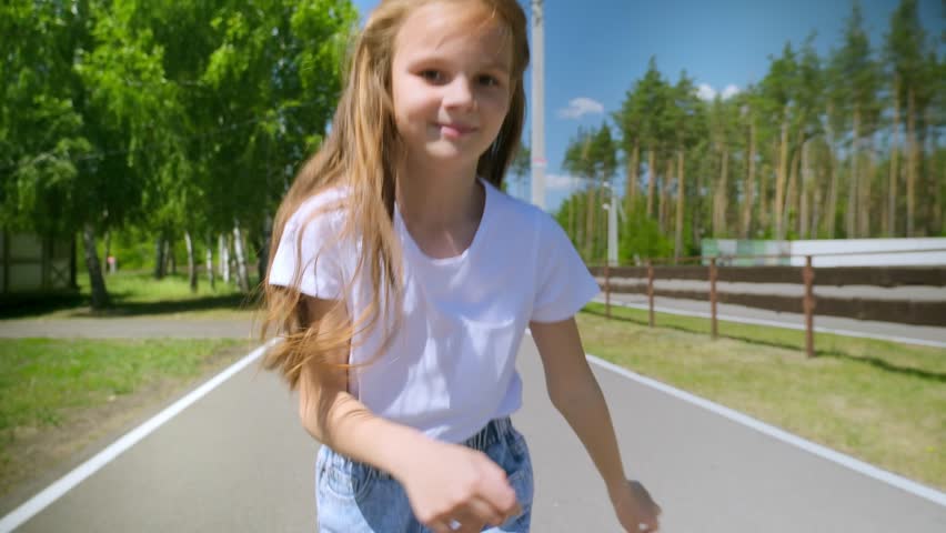 child girl runs along road park. child loves run around laughing merrily. running child. little running kid. playing child forest. nature park outdoor