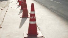 A row of blurred red traffic cones on empty an asphalt road at sunset - Powered by Shutterstock - Get 15% off with code: PIKWIZARD15