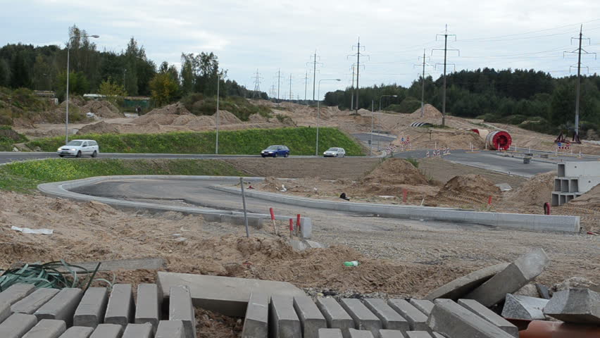concrete road and pavement part road construction site and cars go roundabout way.
