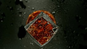 Super Slow Motion of Falling Ice Cube into Cola Drink. Filmed on High Speed Cinema Camera, 1000 fps, Camera Tracking the Target.  - Powered by Shutterstock - Get 15% off with code: PIKWIZARD15
