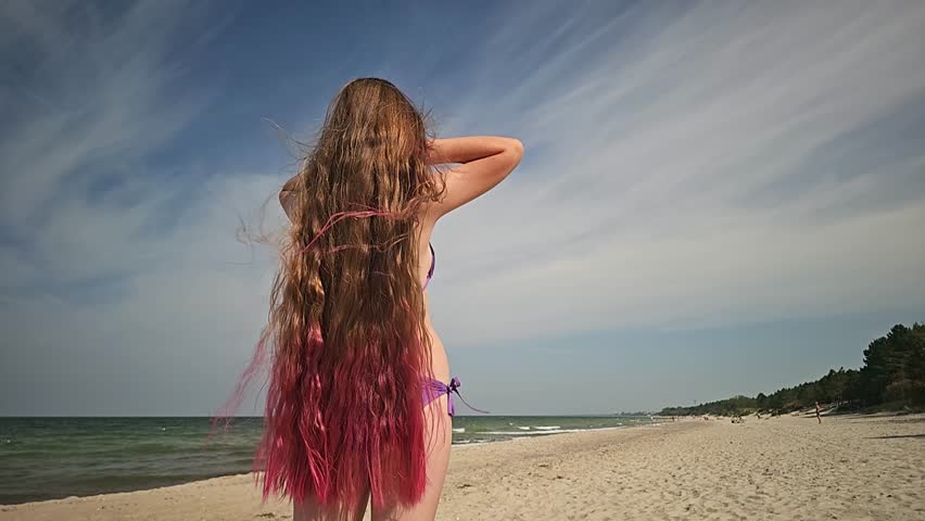 beautiful girl with long hair on the beach, woman posing on the sand, travel to tropical countries, girl smiling, childhood, teenager