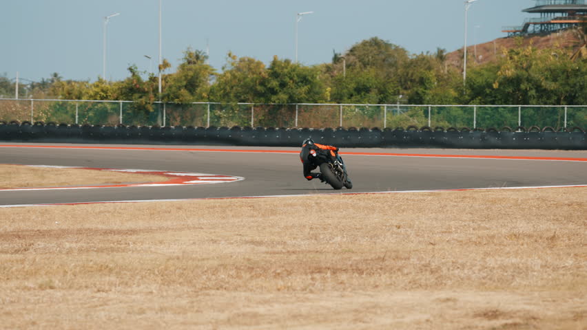 Motorcyclist Rides on a Race Track
