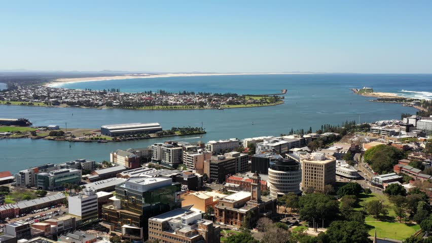 Newcastle city CBD and Pacific ocean waterfront – aerial cityscape in Australia 4k.
