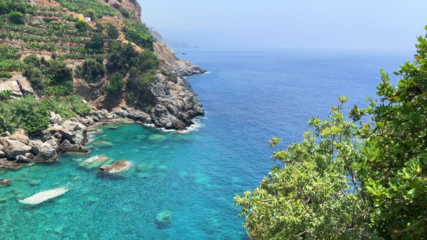 The blue lagoon in Gazipasha. A beautiful sea bay with mountains overgrown with shrubs and banana plantations descending to the sea with the purest water in the village of Guney koyu in Turkey, Alanya