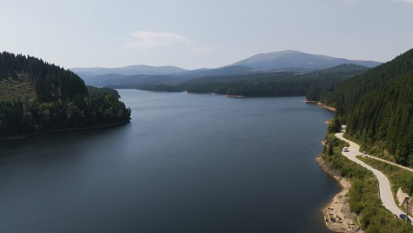 Aerial drone footage of a Oasa Lake from Sureanu mountains, Alba county, Transalpina, Transylvania, Romania.