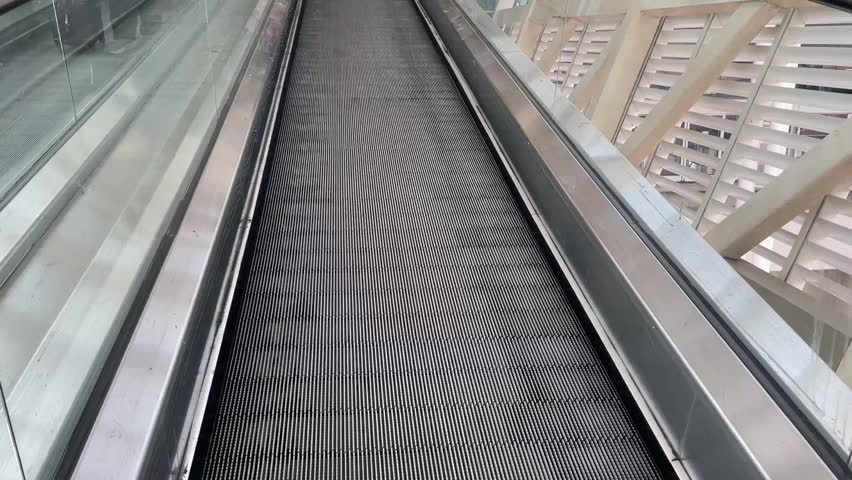 Flat escalator inside the modern building.