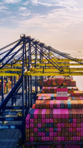Vertical video. Time lapse of Container ship loading and unloading in port.