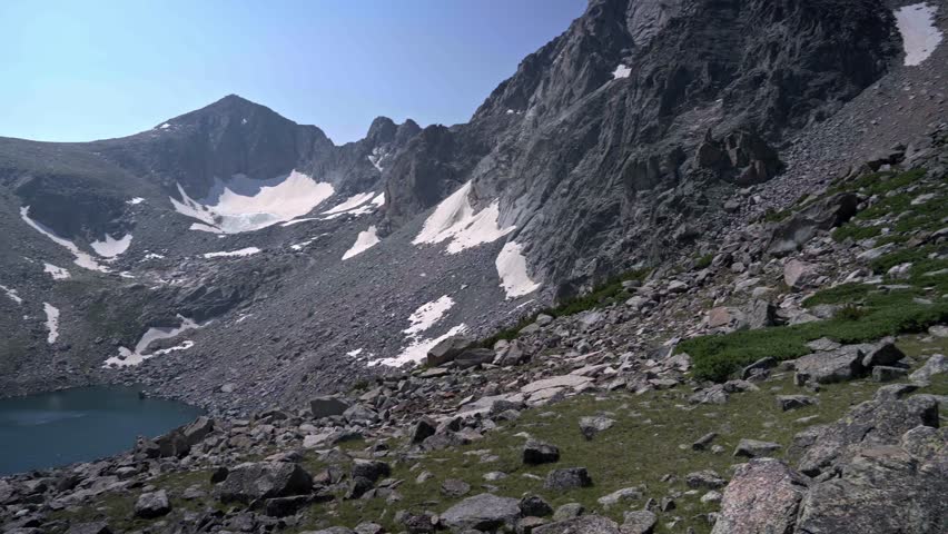 Majestic mountain and lake views of Washakie Pass in Wyoming’s Wind River Range, with stunning alpine scenery, pan from boulder field
