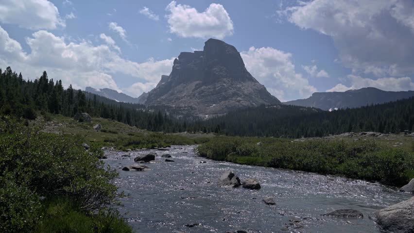 Serene view of Payson Peak and a flowing river in the Wind River Range, Wyoming, showcasing the area’s natural beauty, handheld static
