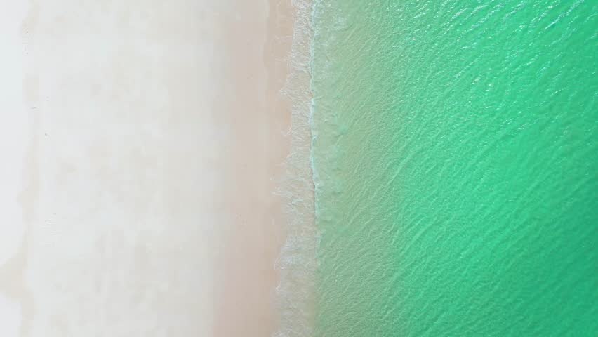 Whitehaven Beach Whitsundays Island peaceful sunny cloudy birdseye aerial drone Airlie National Park Australia AUS QLD outer Great Barrier Reef clear blue turquoise ocean shoreline static shot