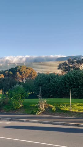 View of the Cape Town stadium through the manicured lawns of the Metropolitan golf club in Green Point, Cape Town, South Africa with Table Mountain nestled in the background 