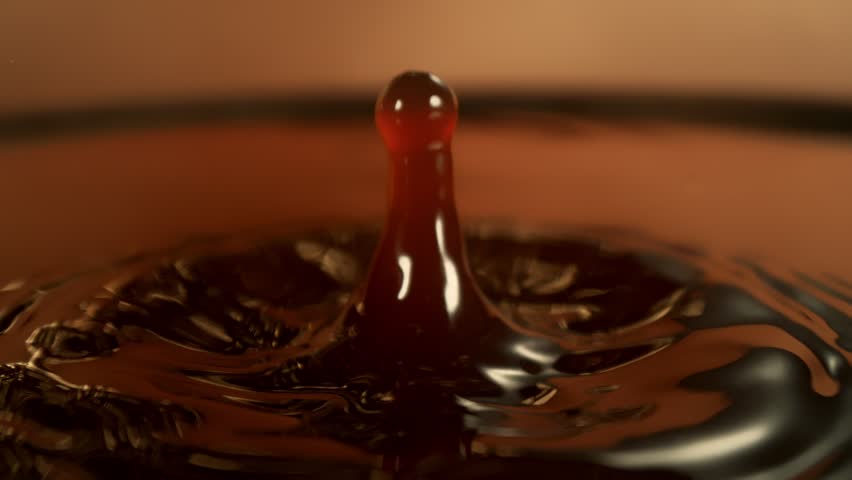 Super Slow Motion Shot of Perfect Two Synchronized Drops Falling into Coffee at 1000fps.