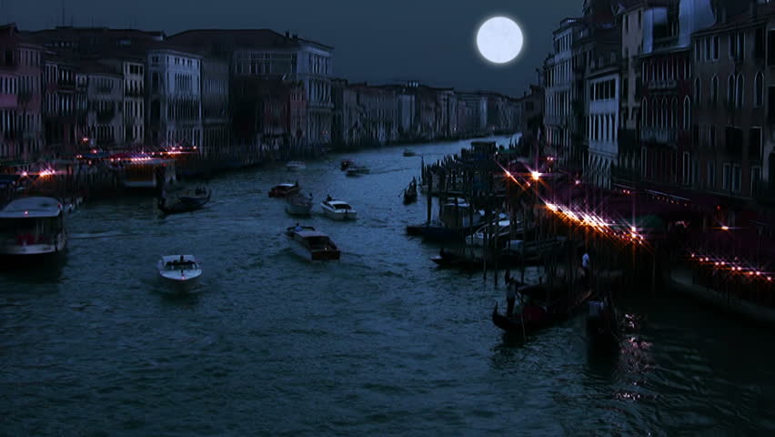 Venice. Grand Canal. Cloudless night sky. A full moon. Heavy traffic of boats