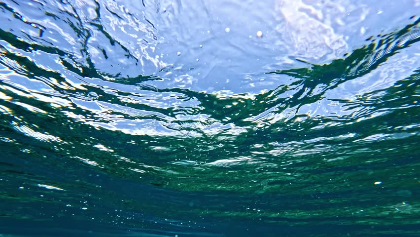 Powerful wave breaks underwater turbulence, wave crashing on the corral reef in tropical ocean. spinning vortex, clouds. powerful nature, strong wave. slow motion.