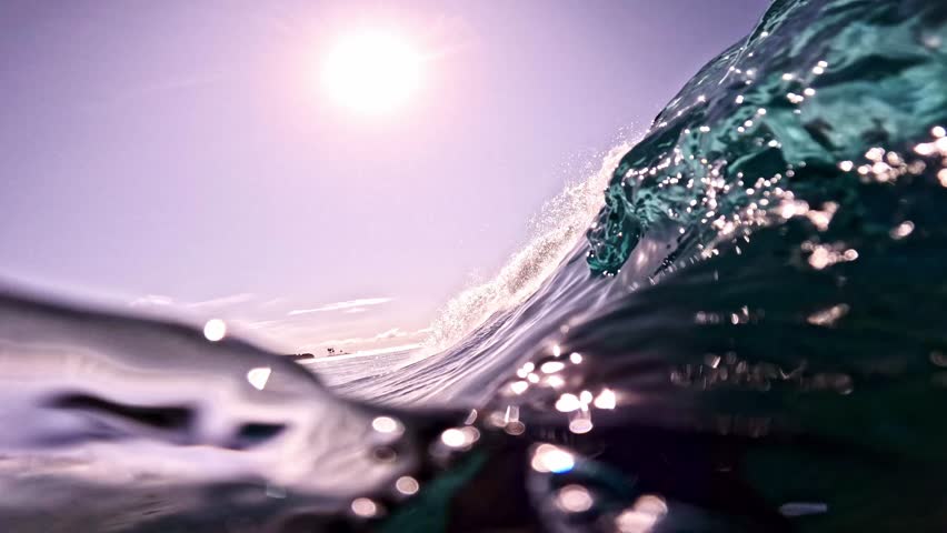 Underwater view of tube wave breaking over coral reef with spinning vortex. powerful nature, strong wave. Abstract bubbles texture, pattern, slow motion 4k.