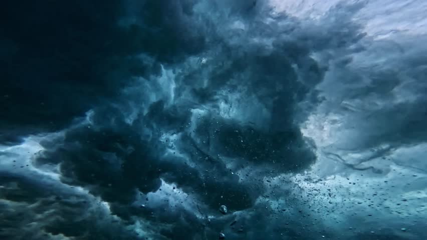 Powerful wave breaks underwater turbulence, wave crashing on the corral reef in tropical ocean. spinning vortex, clouds. powerful nature, strong wave. slow motion.