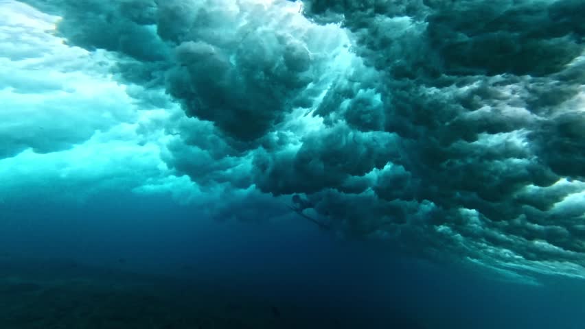 Underwater view of surfer dive under wave breaking over coral reef. Oahu north shore famous action sports destination. travel in Hawaii. slow motion 4k.