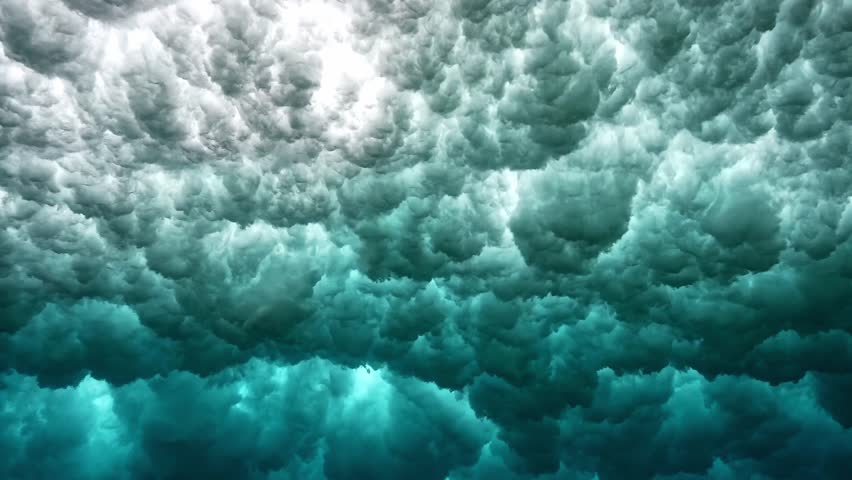 Powerful wave breaks underwater turbulence, wave crashing on the corral reef in tropical ocean. spinning vortex. powerful nature, strong wave. Abstract bubbles texture, pattern, slow motion 4k.