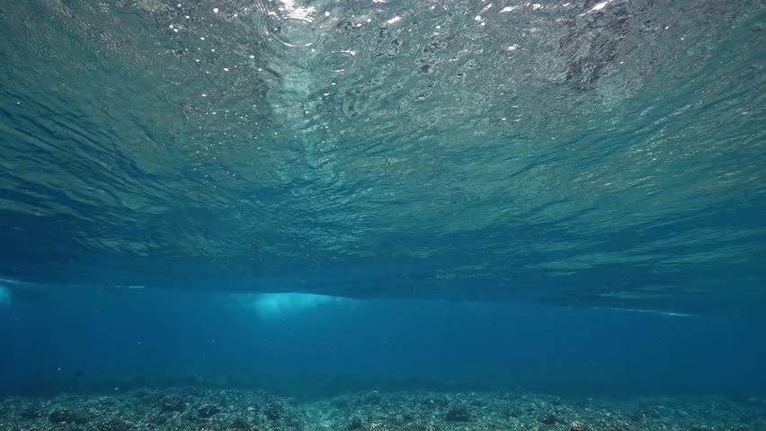 Underwater view of tube wave breaking over coral reef with spinning vortex. powerful nature, strong wave. Abstract bubbles texture, pattern, slow motion 4k.